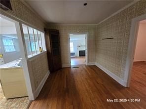 300 Irvington Rd, Kilmarnock, VA 22482 - corridor featuring wood finished floors, plenty of natural light, crown molding, wallpapered walls, and baseboards