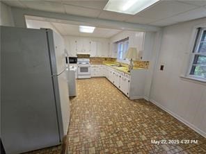 300 Irvington Rd, Kilmarnock, VA 22482 - kitchen with freestanding refrigerator, gas range gas stove, white cabinetry, wall oven, and light countertops