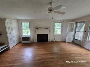 300 Irvington Rd, Kilmarnock, VA 22482 - unfurnished living room featuring plenty of natural light, ceiling fan, a fireplace, and wood finished floors