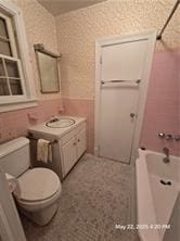 300 Irvington Rd, Kilmarnock, VA 22482 - bathroom with toilet, vanity, and shower / bathtub combination