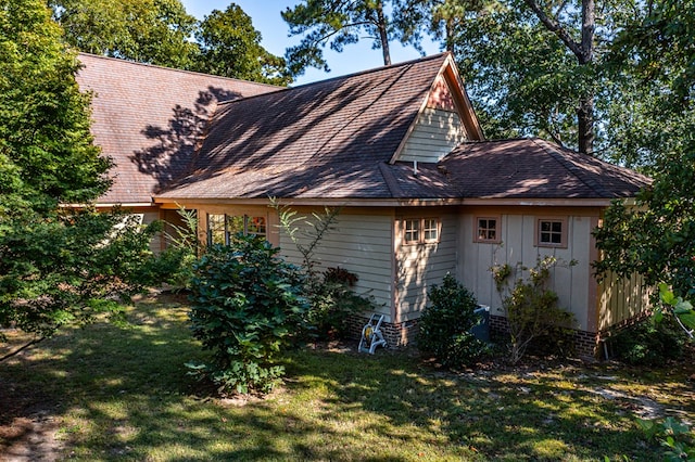 view of side of home with a lawn