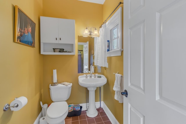 bathroom with sink, tile patterned flooring, and toilet