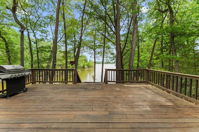 wooden deck featuring area for grilling and a water view