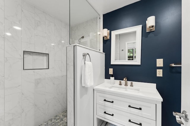 bathroom featuring a walk in shower and vanity