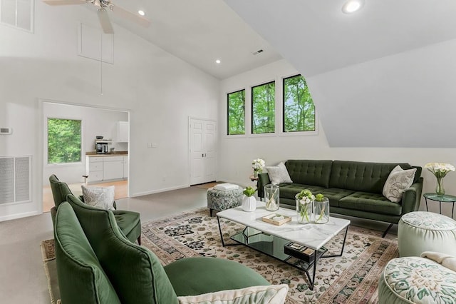 carpeted living room with visible vents, a healthy amount of sunlight, and high vaulted ceiling