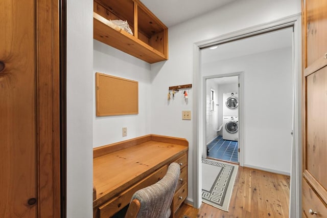 office with stacked washer and dryer and hardwood / wood-style floors