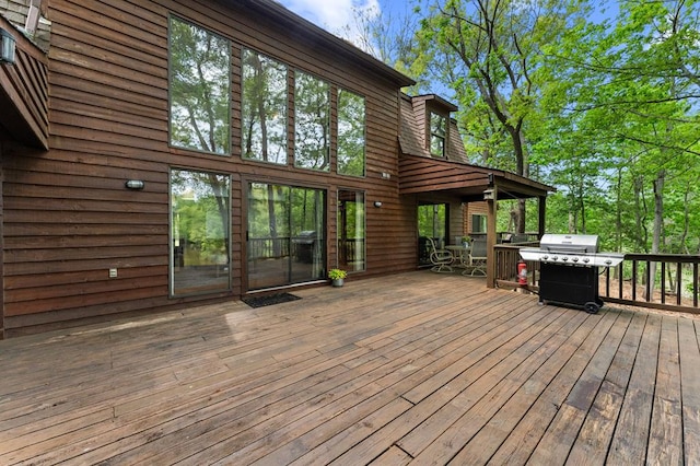 deck featuring area for grilling and outdoor dining space