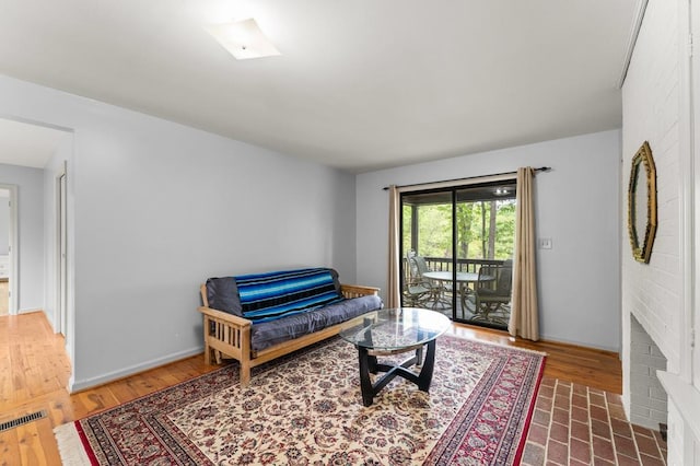 living area featuring visible vents and wood finished floors