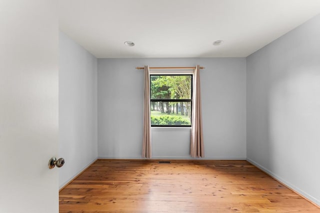 spare room with visible vents and wood finished floors