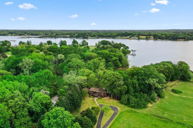 aerial view featuring a wooded view and a water view
