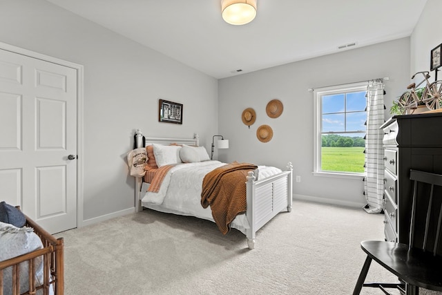 bedroom featuring light colored carpet