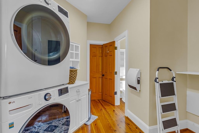 744 Possum Point Prt, Haywood, VA 23138 - laundry room featuring cabinet space, stacked washer / drying machine, and light wood-style floors