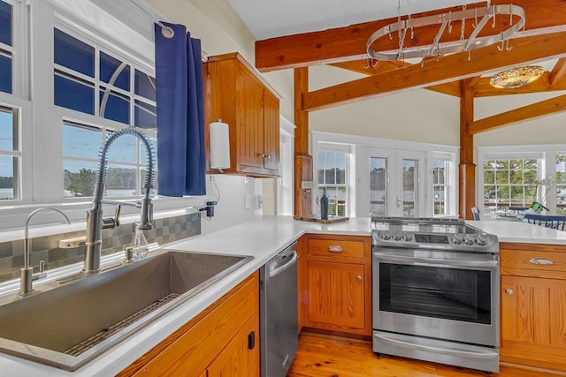 744 Possum Point Prt, Haywood, VA 23138 - kitchen featuring appliances with stainless steel finishes, brown cabinetry, a peninsula, and light countertops