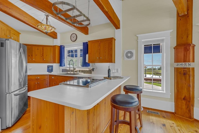 744 Possum Point Prt, Haywood, VA 23138 - kitchen with beam ceiling, freestanding refrigerator, a peninsula, light wood-style flooring, and plenty of natural light