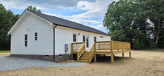 rear view of house with a wooden deck and crawl space