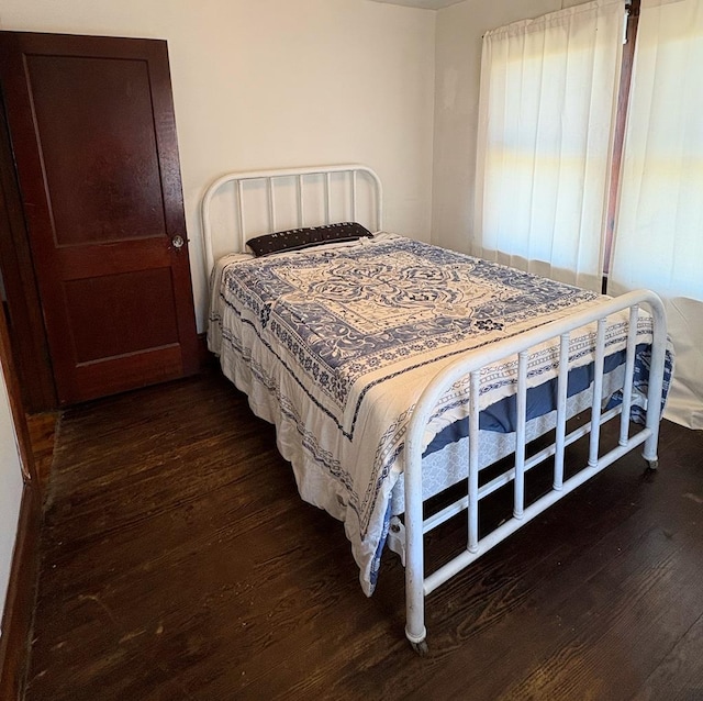 bedroom featuring dark wood finished floors