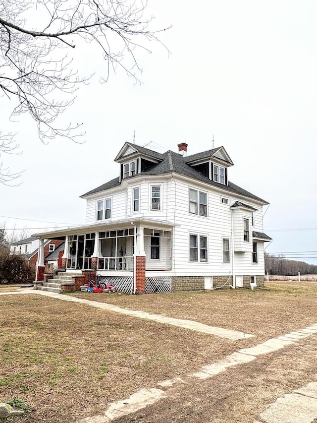 view of front of property with a chimney and a porch