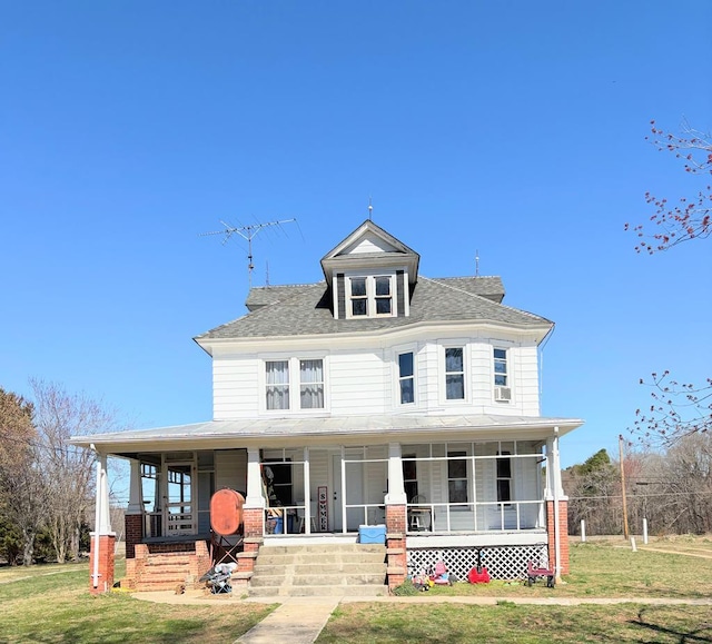 view of front facade featuring a front lawn, a porch, and roof with shingles
