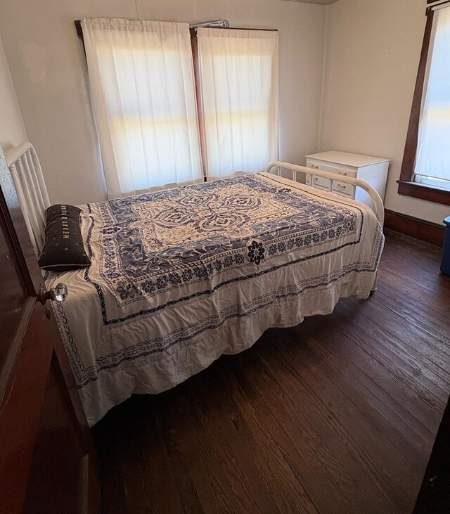 bedroom featuring baseboards and wood finished floors