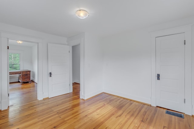 spare room with light wood-type flooring