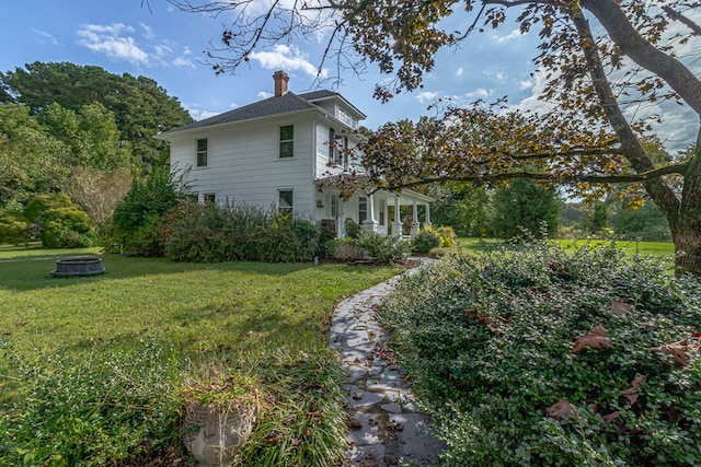 rear view of house featuring a lawn