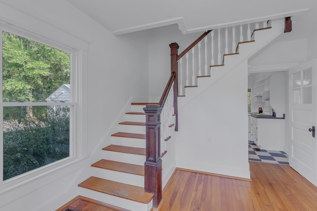 stairway with hardwood / wood-style flooring