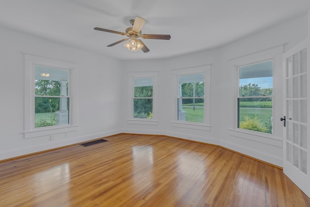 empty room with ceiling fan and light wood-type flooring