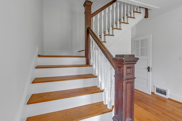 stairs featuring hardwood / wood-style flooring