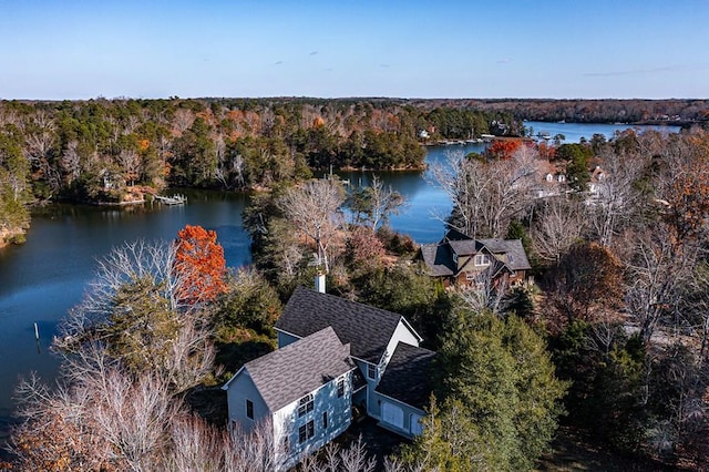 aerial view featuring a water view and a wooded view