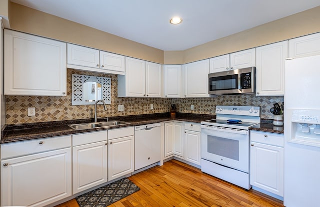 30 Heatherfield Ct, Kilmarnock, VA 22482 - kitchen featuring white appliances, white cabinets, light wood-type flooring, decorative backsplash, and recessed lighting