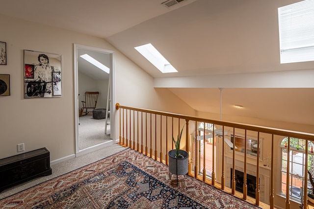 30 Heatherfield Ct, Kilmarnock, VA 22482 - hall with vaulted ceiling, a skylight, and carpet floors