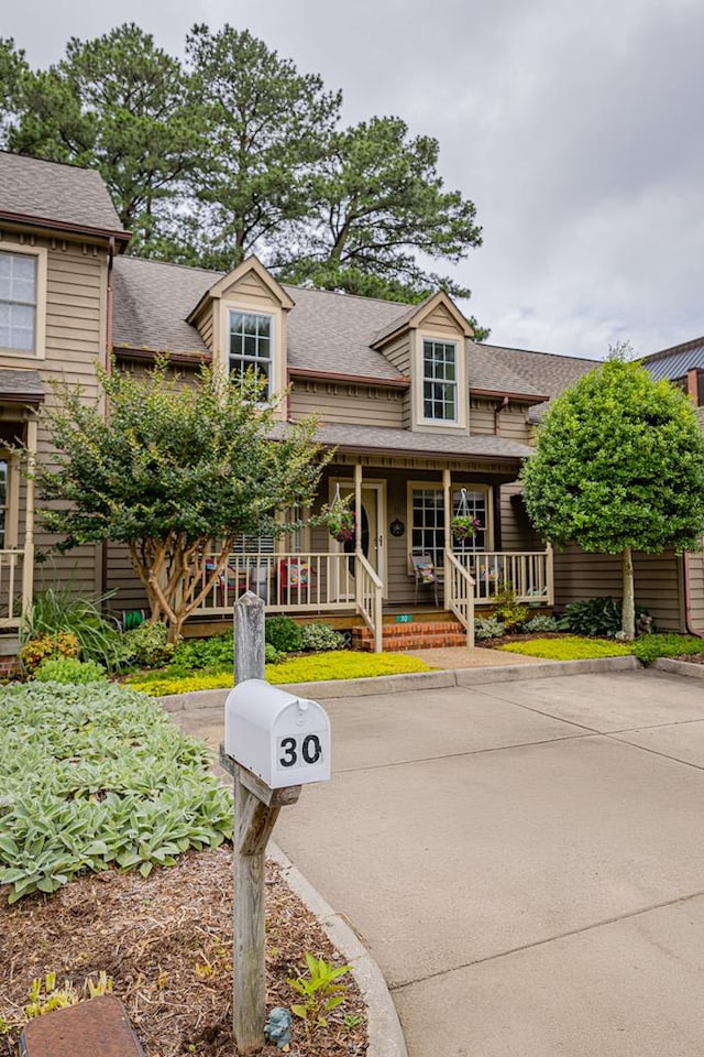 30 Heatherfield Ct, Kilmarnock, VA 22482 - view of front of house with covered porch and a shingled roof