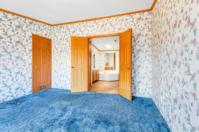 carpeted spare room featuring ornamental molding