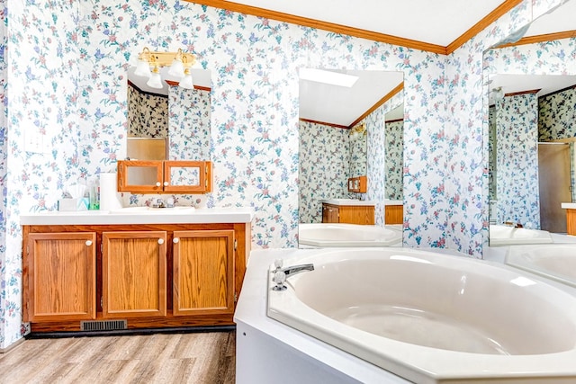 bathroom featuring a bath, crown molding, lofted ceiling, vanity, and hardwood / wood-style flooring