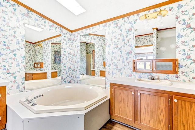 bathroom featuring vanity, ornamental molding, and a tub