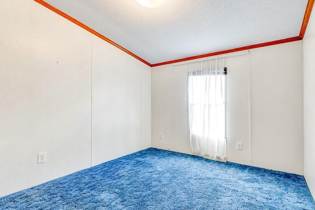 carpeted empty room with a textured ceiling and lofted ceiling