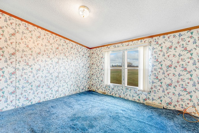 carpeted empty room with a textured ceiling and crown molding