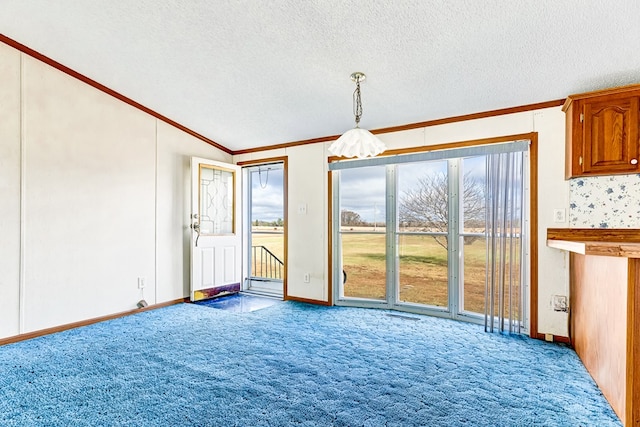 interior space featuring a textured ceiling, light colored carpet, lofted ceiling, and ornamental molding