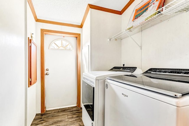 washroom with a textured ceiling, separate washer and dryer, dark hardwood / wood-style floors, and crown molding