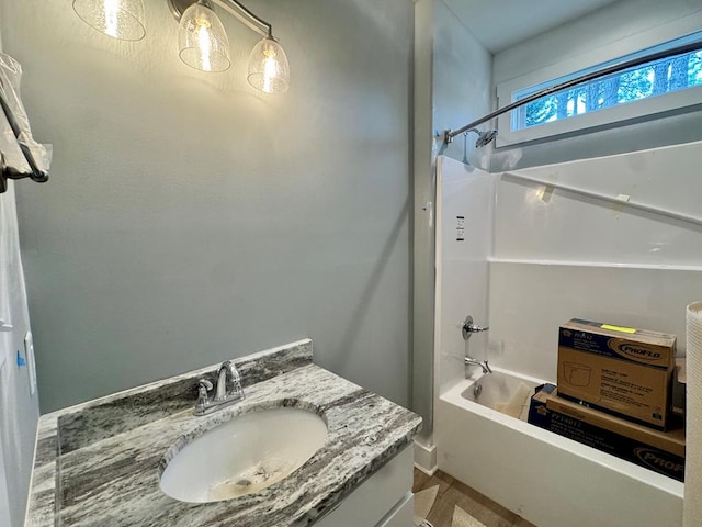 bathroom featuring bathtub / shower combination and vanity