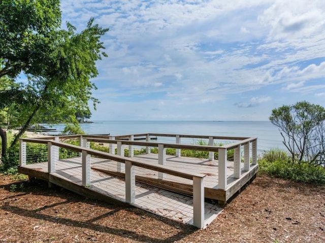 exterior space featuring a deck with water view