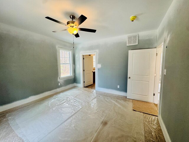 unfurnished bedroom with visible vents, ceiling fan, and baseboards