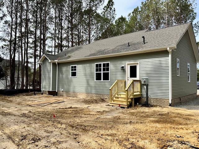 back of property with crawl space and roof with shingles