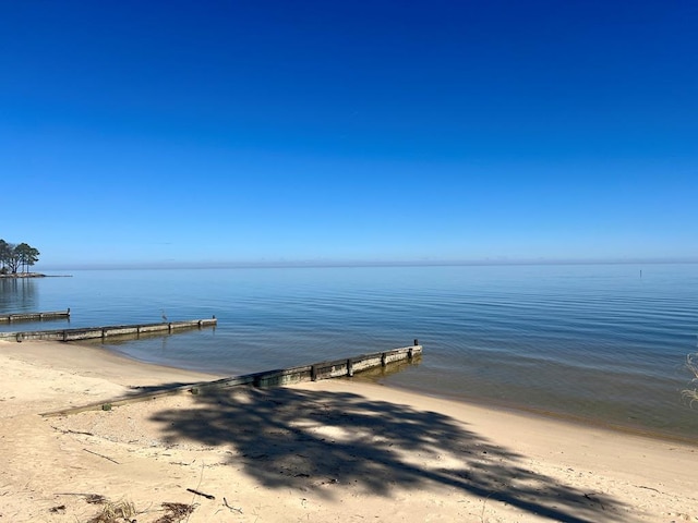 dock area featuring a view of the beach and a water view