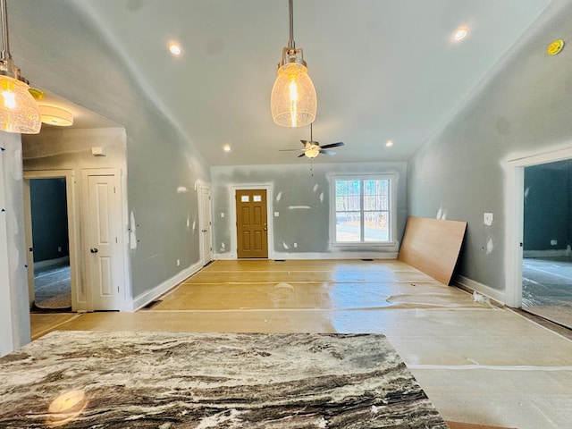 entryway featuring recessed lighting, baseboards, and high vaulted ceiling