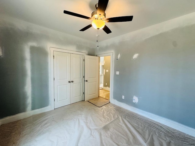 unfurnished bedroom with a closet, baseboards, and ceiling fan