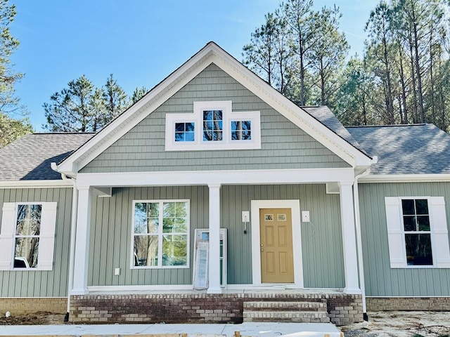 view of front of house with a porch and a shingled roof