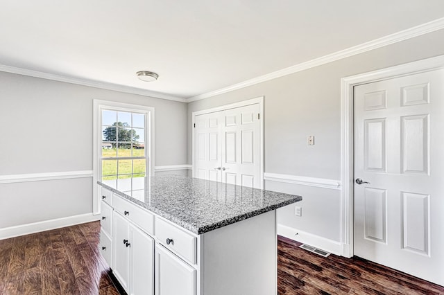337 Sunnyside Rd, Tappahannock, VA 22560 - kitchen with stone countertops, dark wood finished floors, white cabinetry, ornamental molding, and a center island