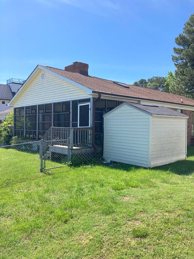 899 N Glebe Rd, Montross, VA 22520 - back of property with a sunroom, a shed, a chimney, an outdoor structure, and a lawn