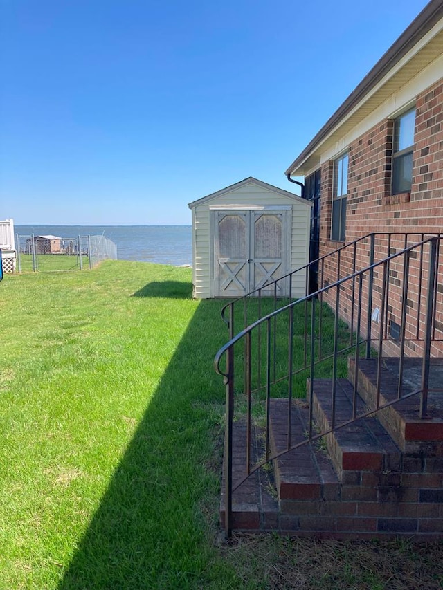 899 N Glebe Rd, Montross, VA 22520 - view of yard featuring a storage unit, a water view, and an outbuilding